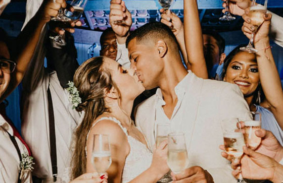 couple kissing at their wedding party